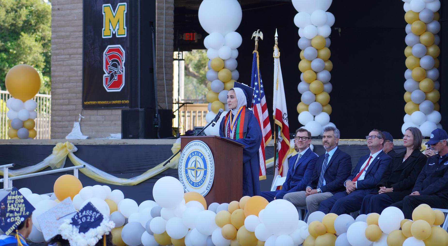Marwa Sahak (2025 Valedictorian) on the podium