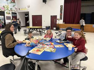 Family enjoying meals and activities around a blue table.