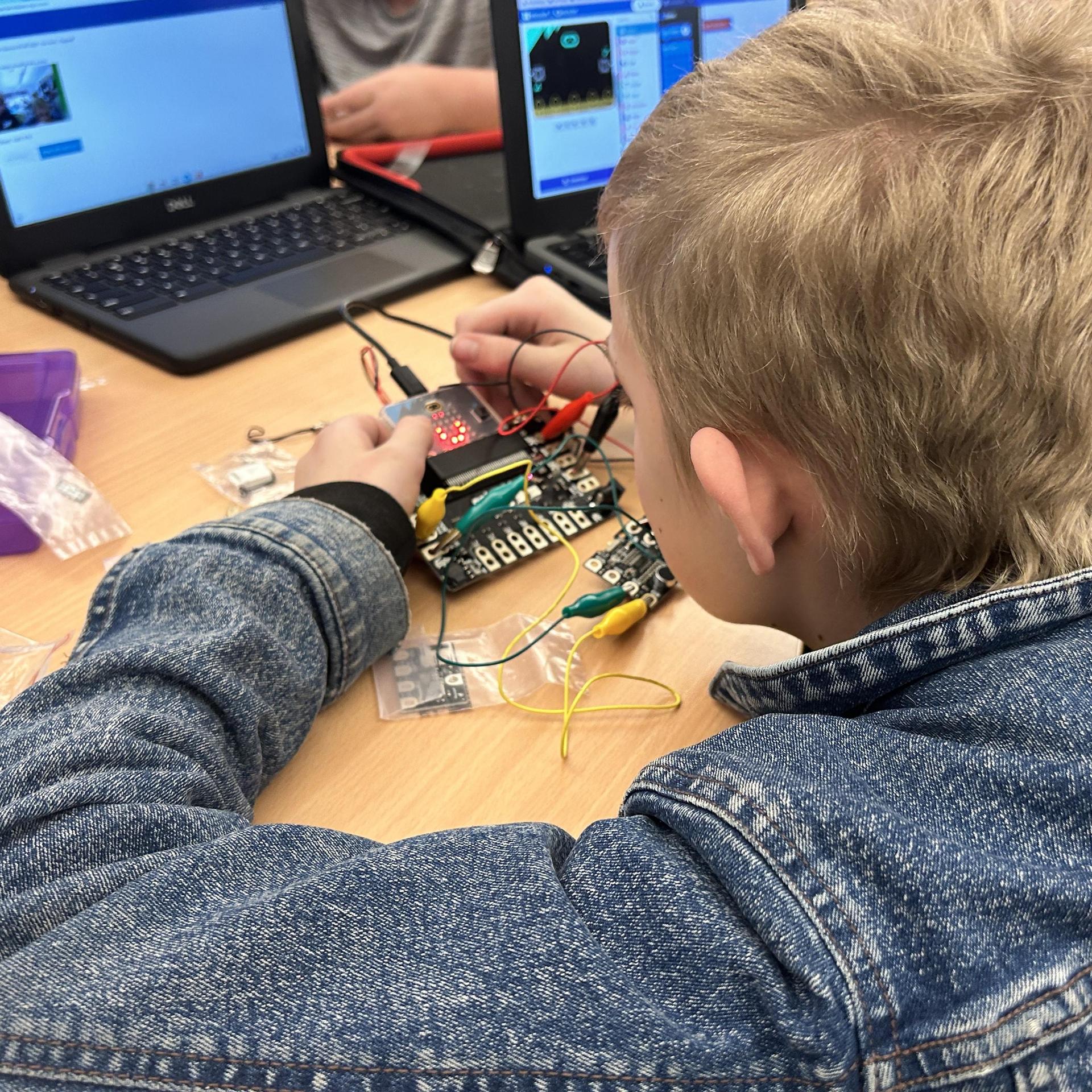 student coding on computer