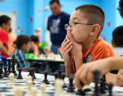 child with chess board