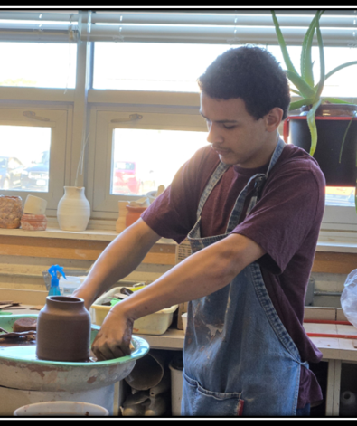 MHS student using the pottery wheel