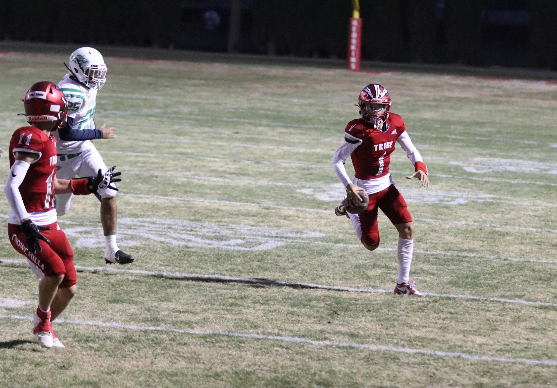 varsity football players in action against Riverdale