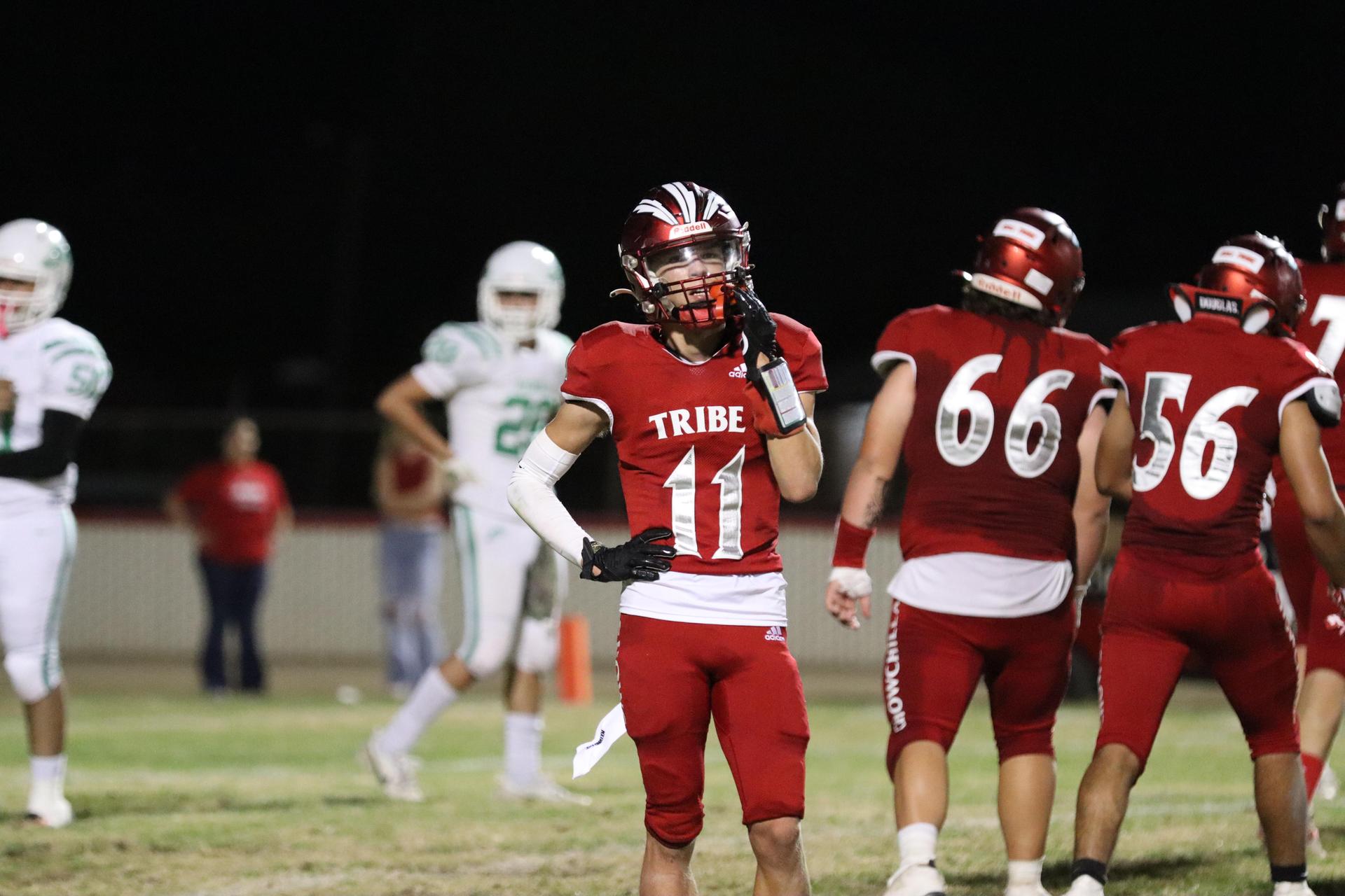 varsity football players in action against Riverdale