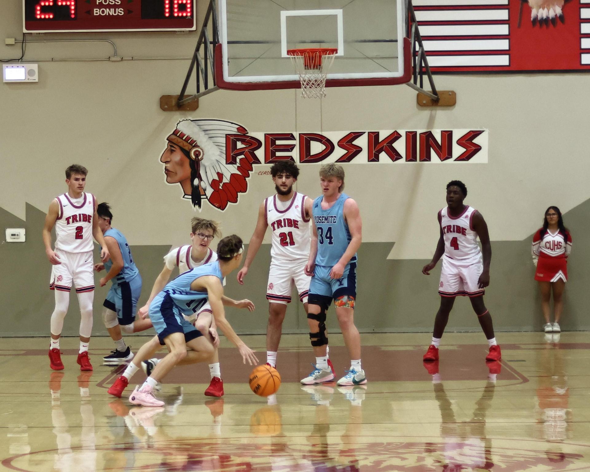 Varsity boys playing basketball against yosemite