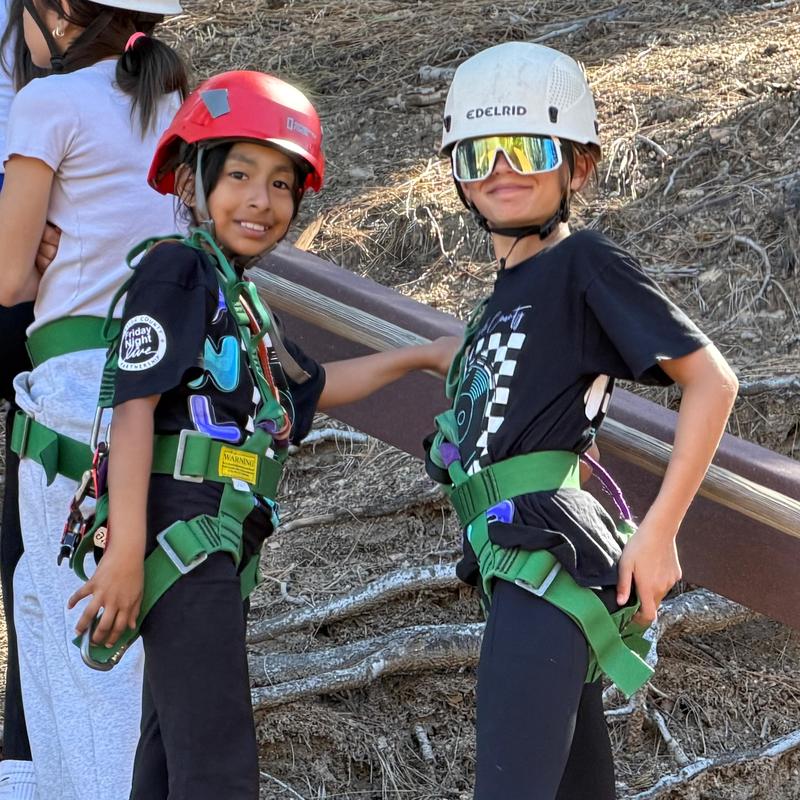 two elementary students waiting in line for high ropes course
