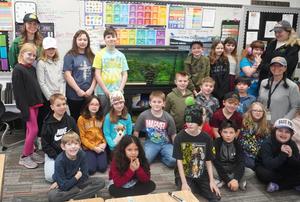Mrs. Boersma's class is pictured in front of the fish tank.