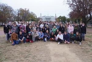 large group of students in front of white house