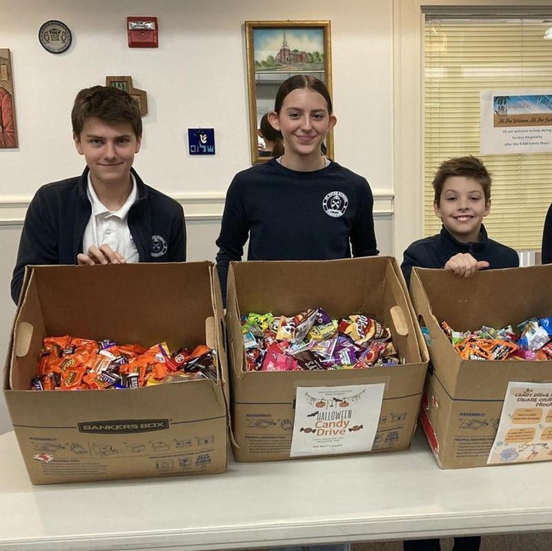 Philanthropy in Action: Members of Student Council show off the 72lbs of candy donated by our students from their own "treasure" of Halloween candy.
