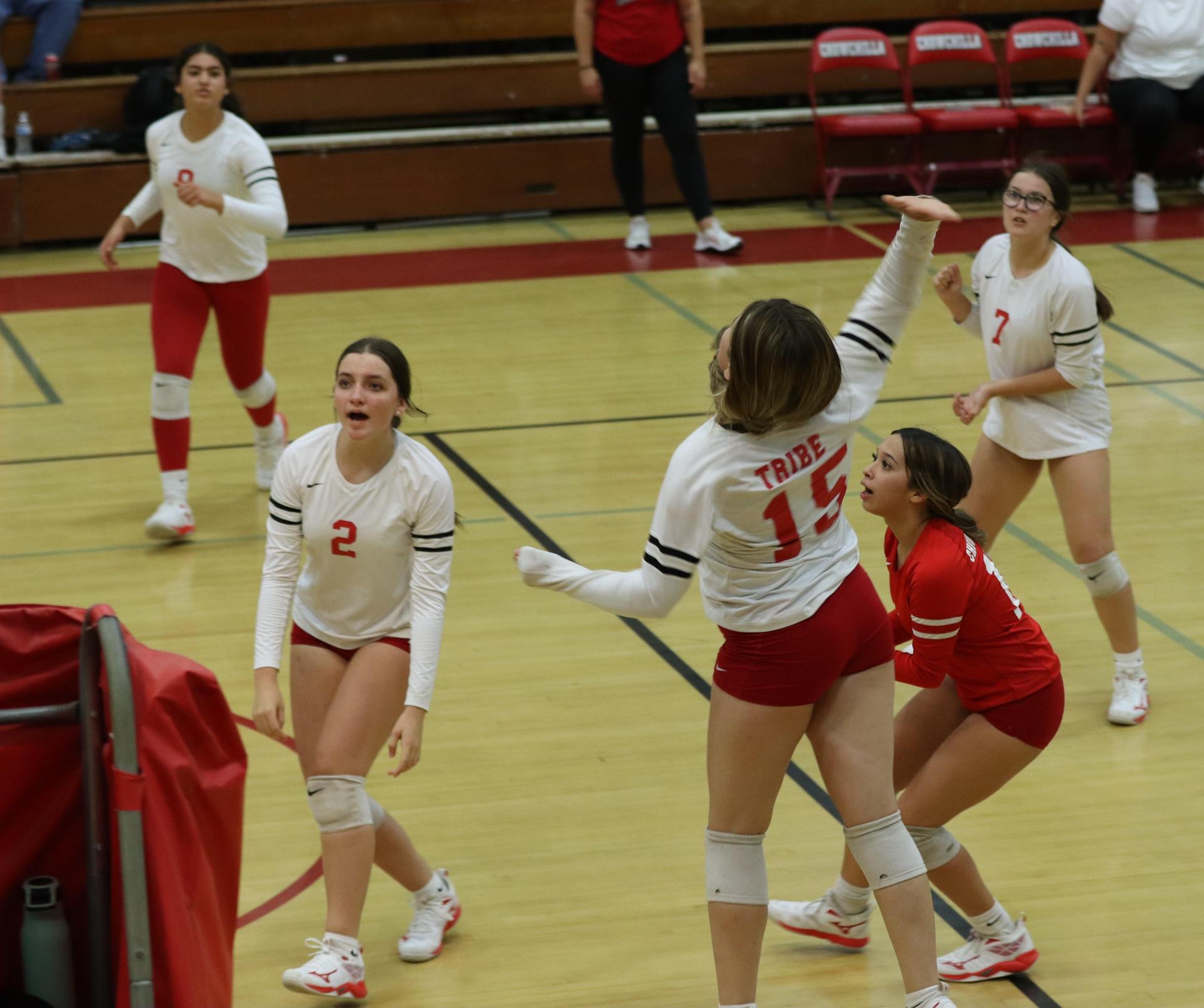 varsity volleyball players in action against liberty