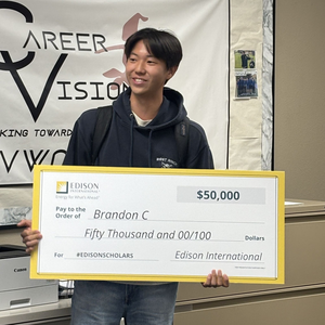 Brandon Chang holding an oversized check from Edison