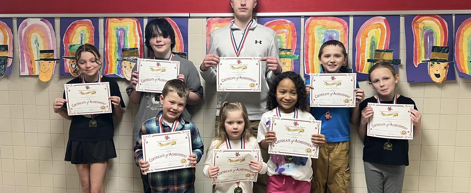 students holding award certificates