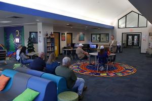 Dr. Brown addressing attendees at the October Coffee & Conversation Meetup in the Partin Library.
