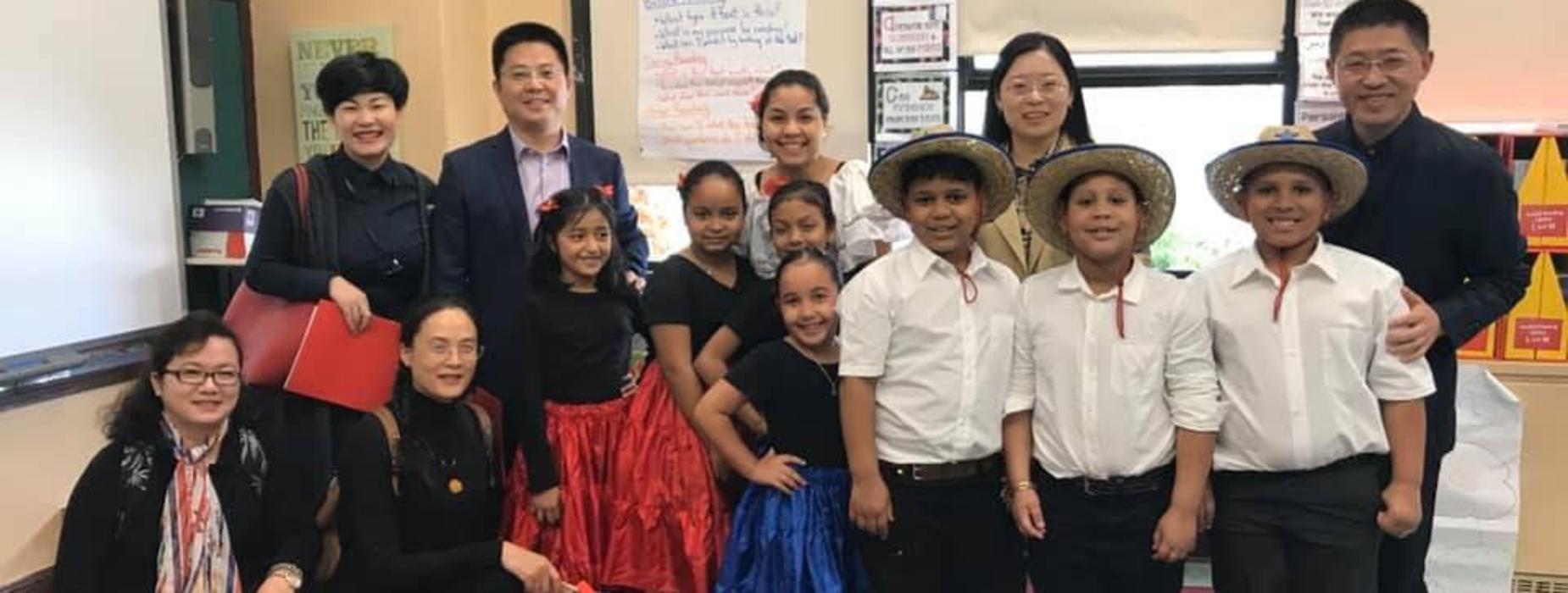 Visitors from The Zheijang Provincial Department of Education congratulate a 3rd grade class after a dance performance.