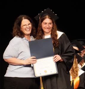 Robin Walters presents a scholarship to Jenna Robinett.