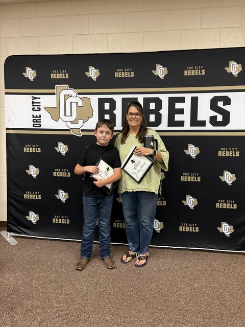 Student and Teacher with award certificates