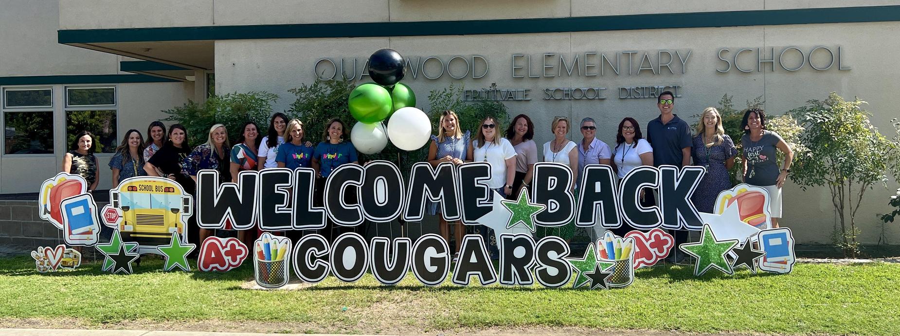 welcome back sign with staff