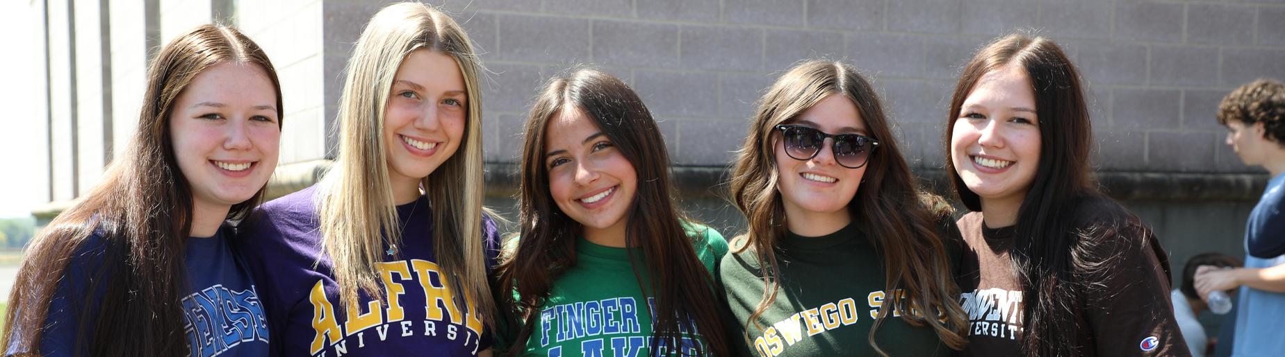 graduating seniors with college shirts