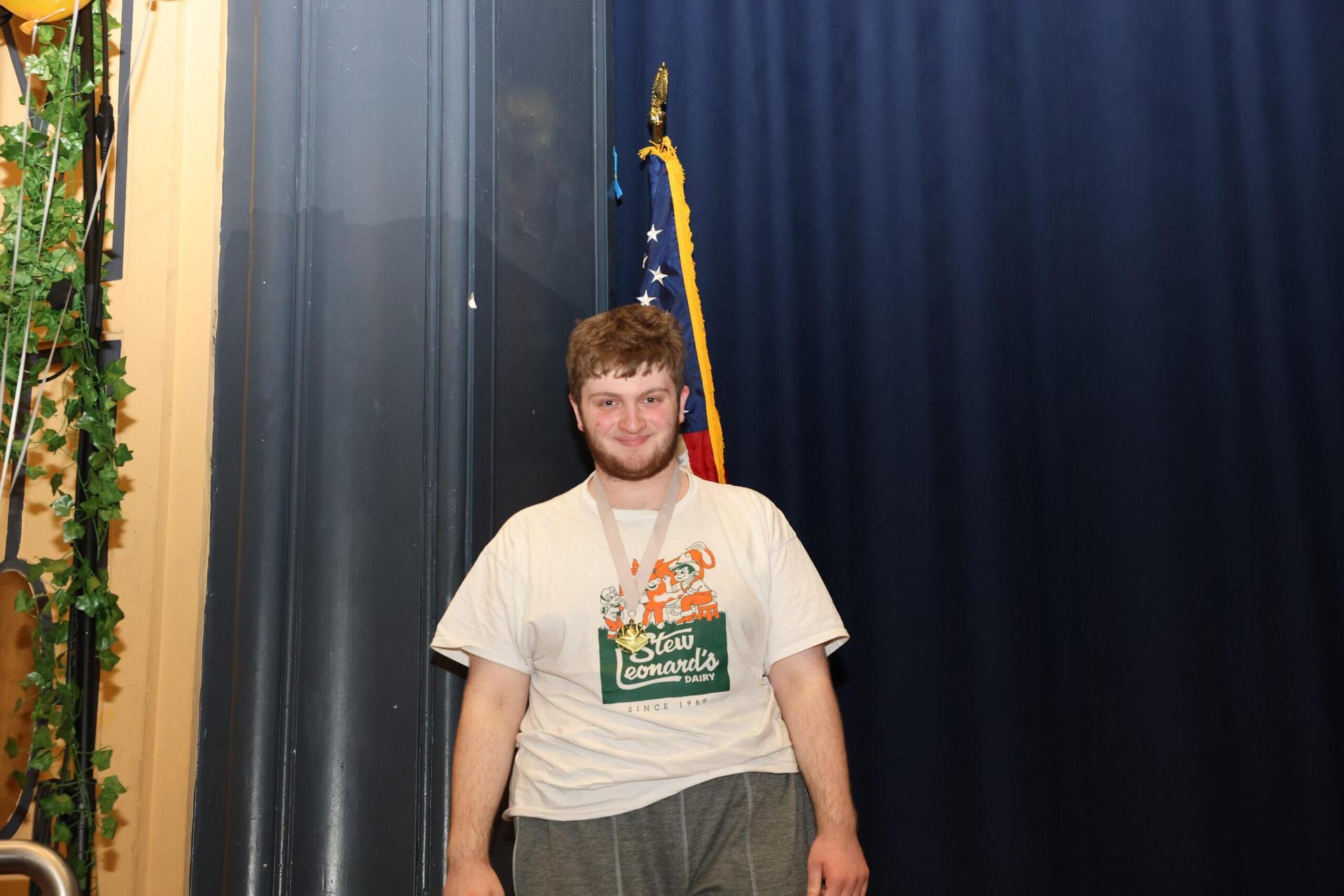 Student posing in front of the flag
