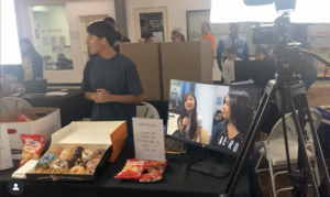 students operate video equipment at a event in the village academy center