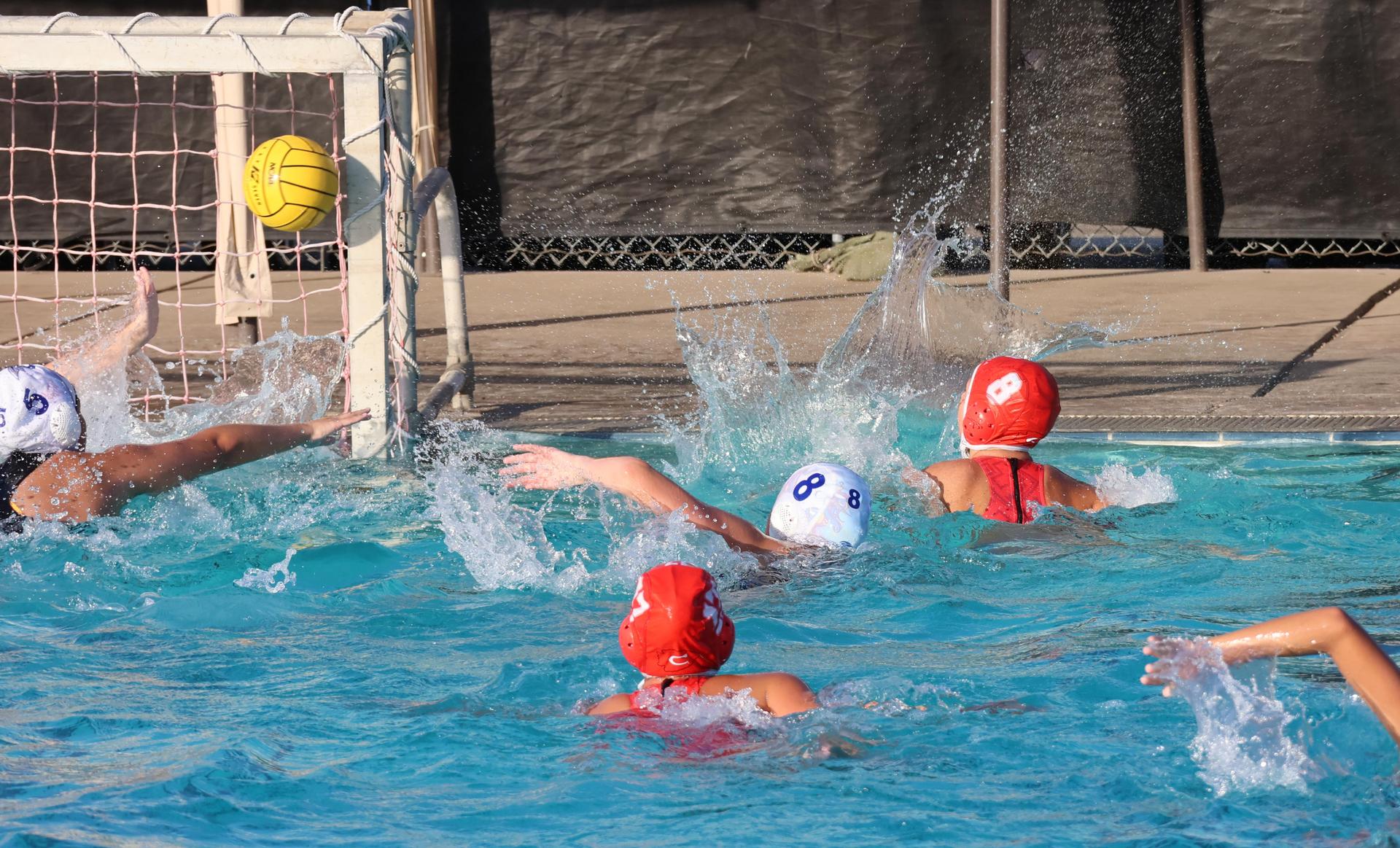 girls playing water polo against Sanger West