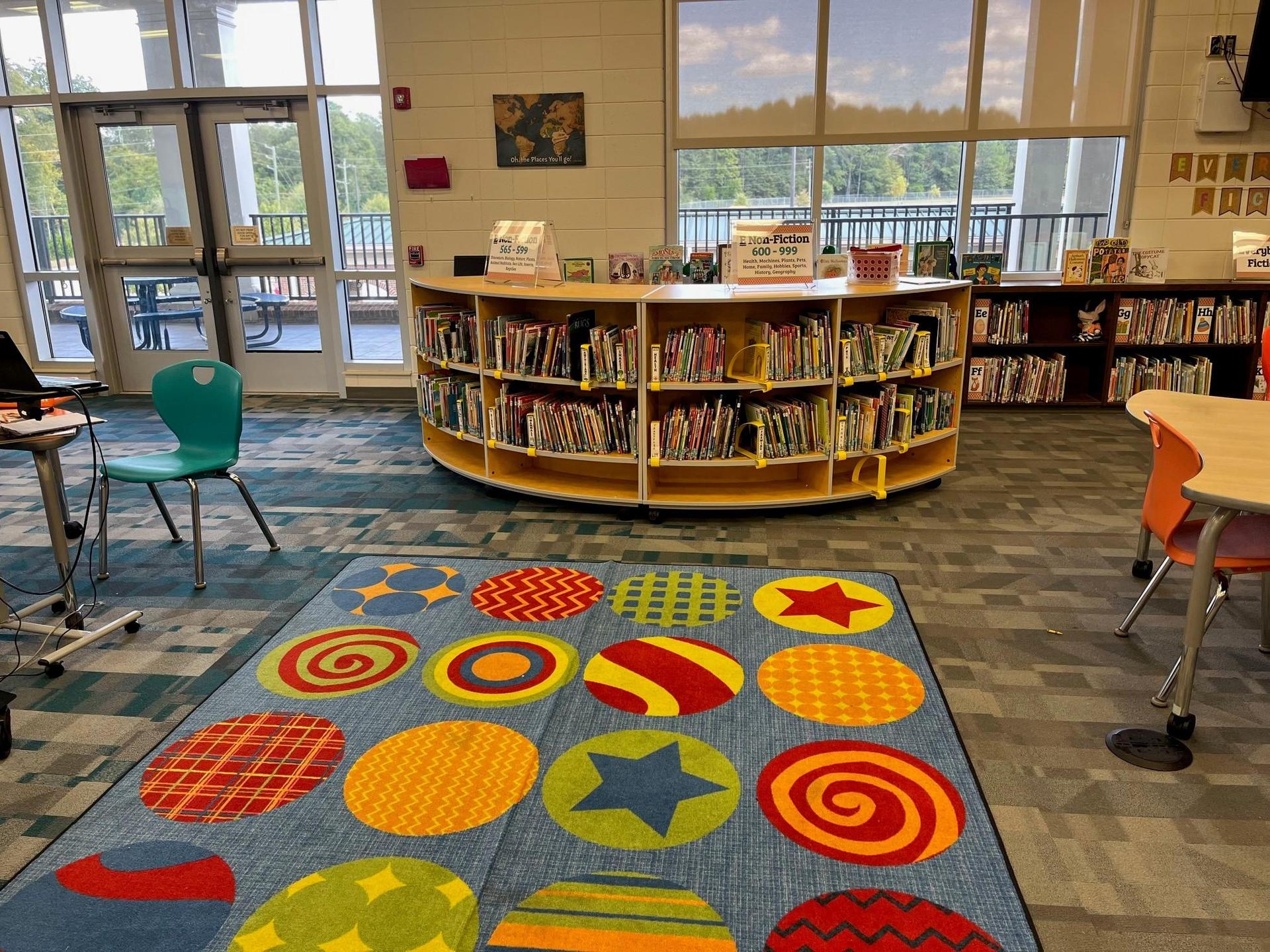 Grovetown Learning Commons space including tables, chairs, and shelves of books.