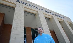 Principal Luker in front of school