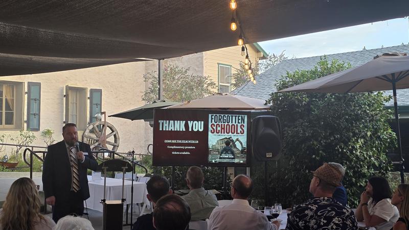 man presenting outside at a boards dinner