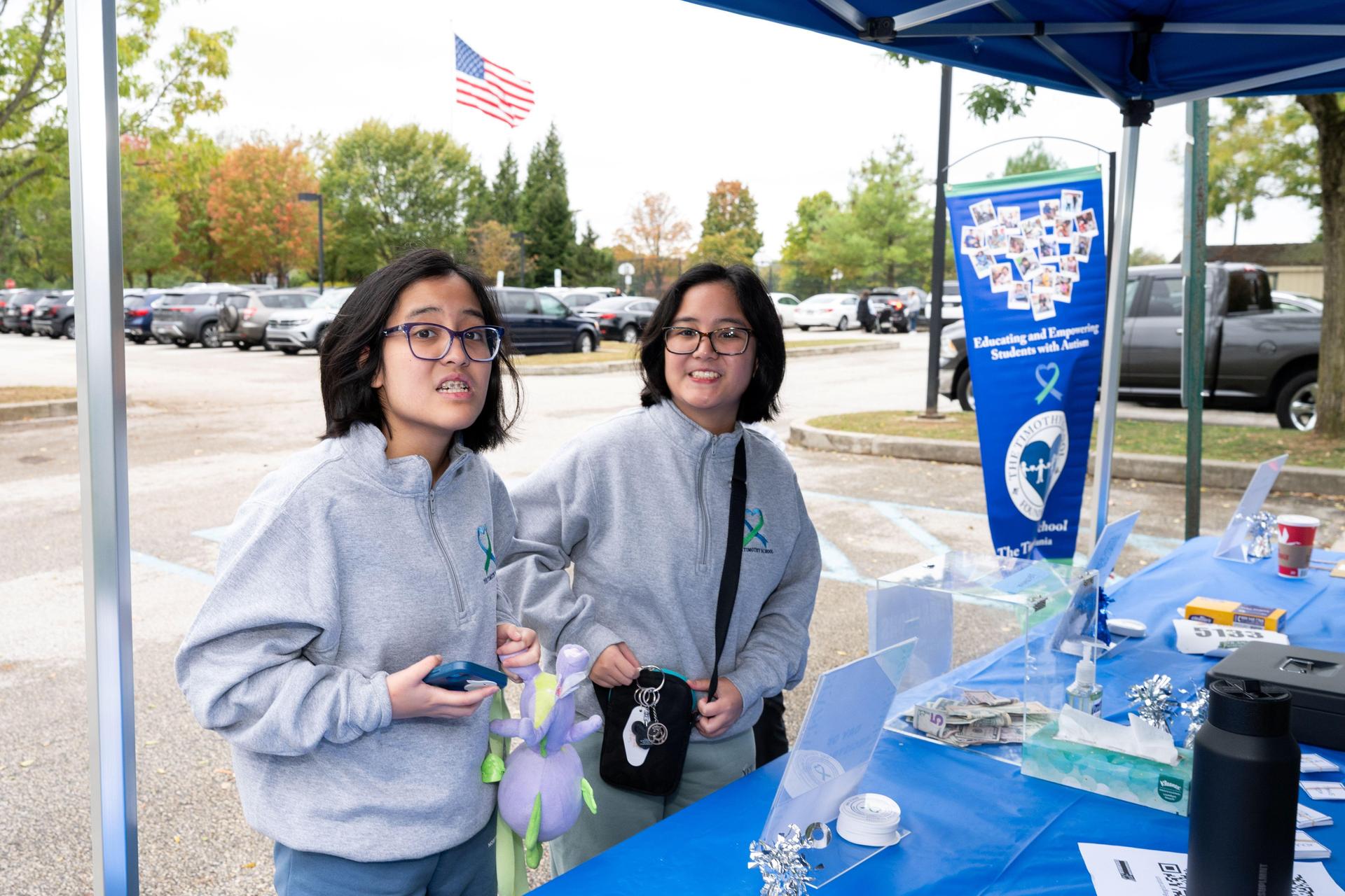Two students outside at event.