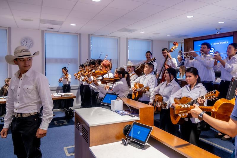 students playing instruments and singing