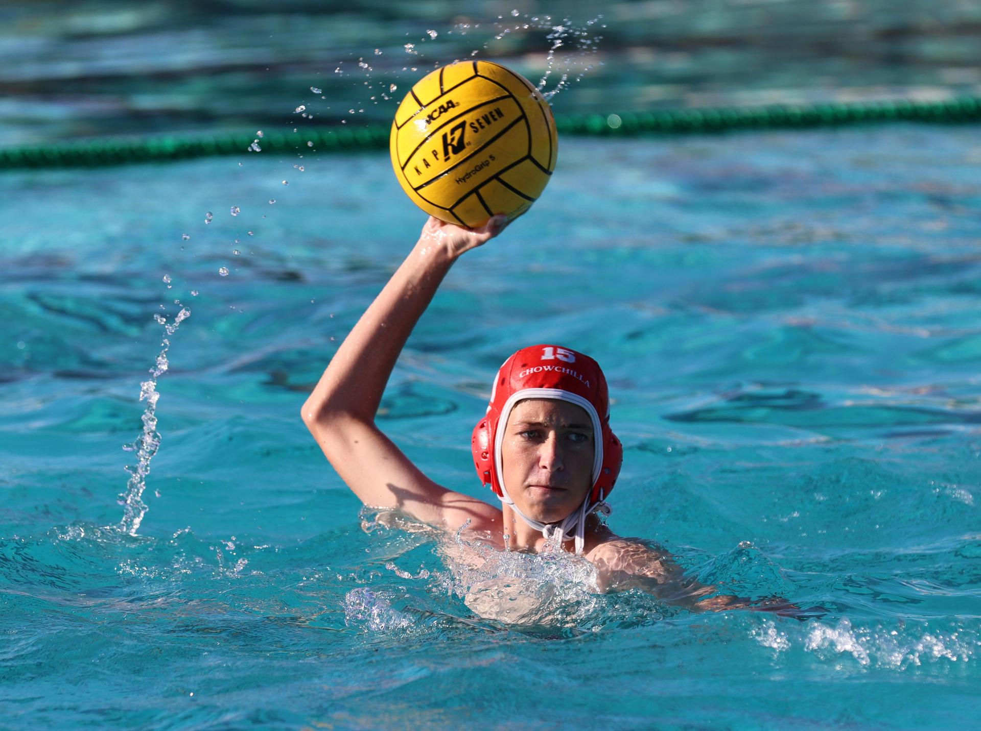 boys water polo players in action against hoover