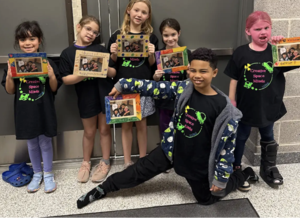 A team of elementary students posing in a hallway at the Odyssey of the Mind competition.