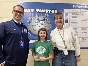 child standing between two adults