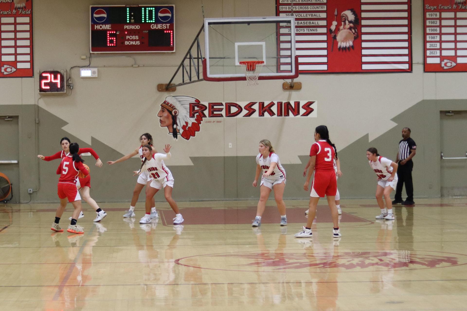 varsity girls playing basketball against mclane