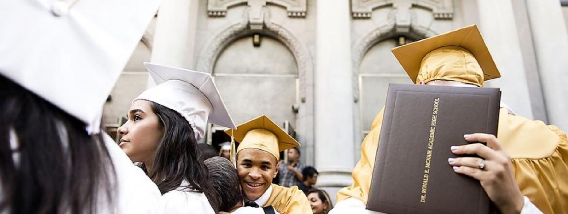 Graduates outside of the building