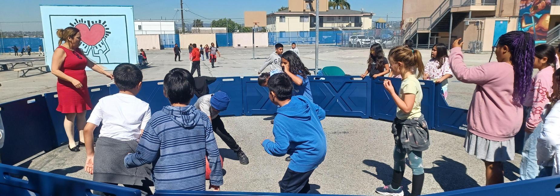 Principal Mura plays GaGa Ball with some students.