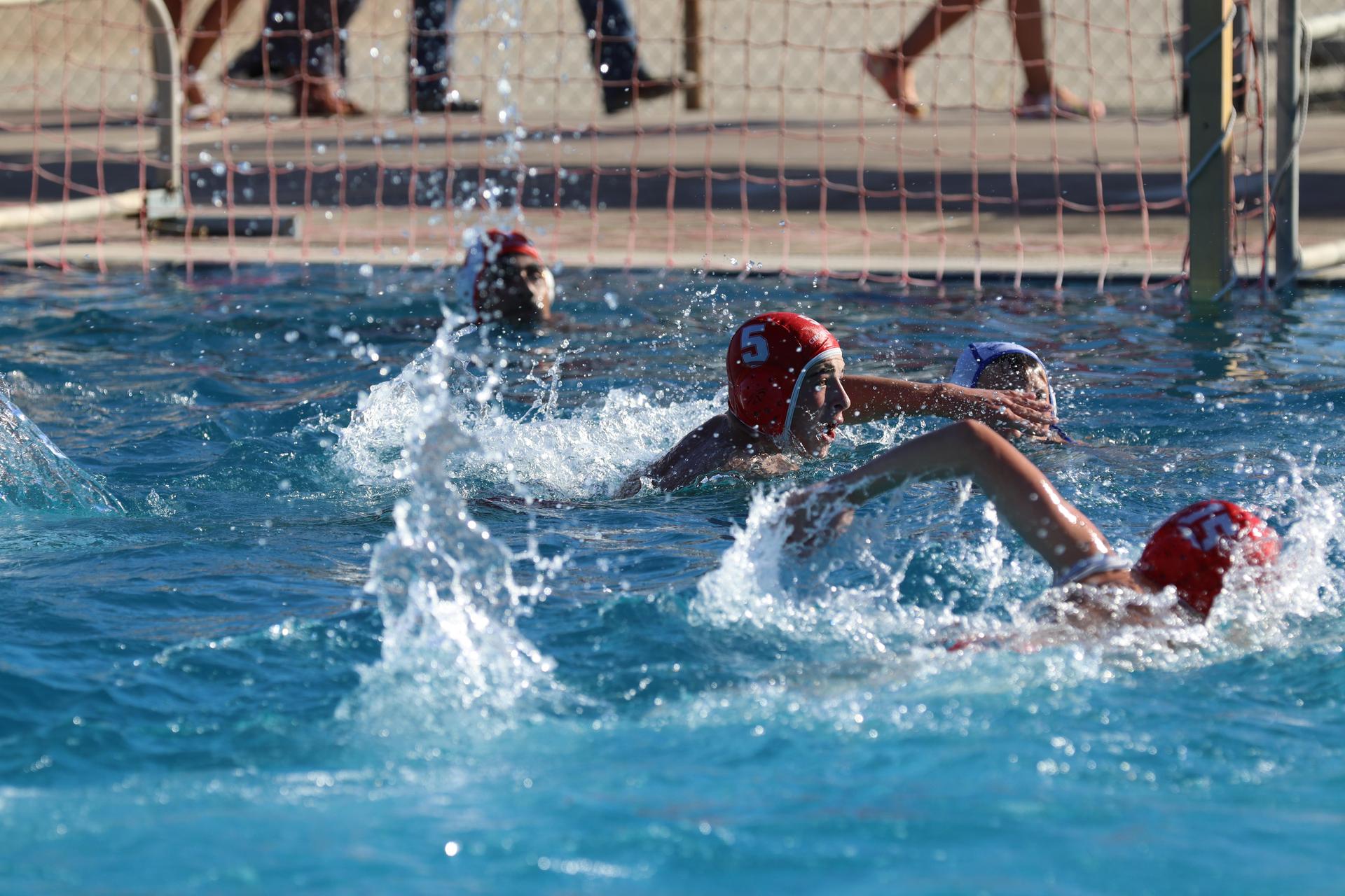 boys playing water polo against Madera