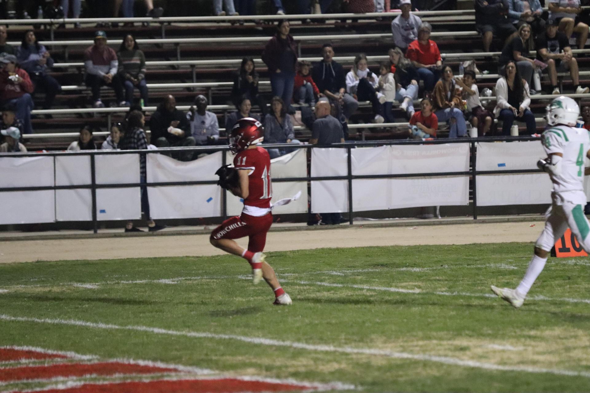varsity football players in action against Riverdale