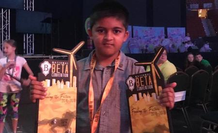 Student holding trophies at National Beta Club Convention in Oklahoma City