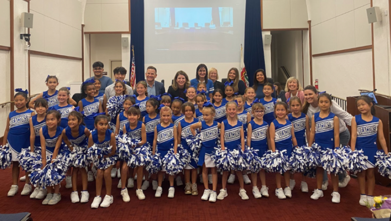 Student Cheerleaders and Board Members posing for photograph