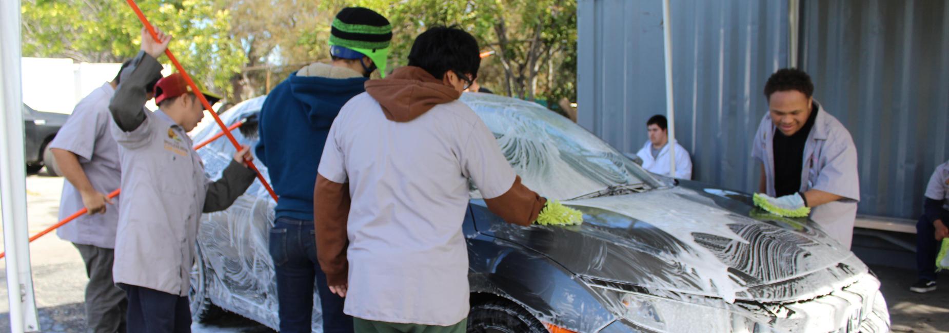 Student washing a car