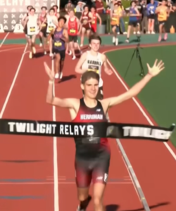 Picture of Jackson Spencer winning the mile race.