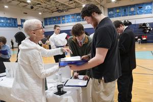 Student gets some financial information from a volunteer at Reality Fair
