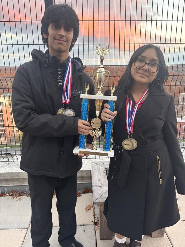 Students holding a trophy.