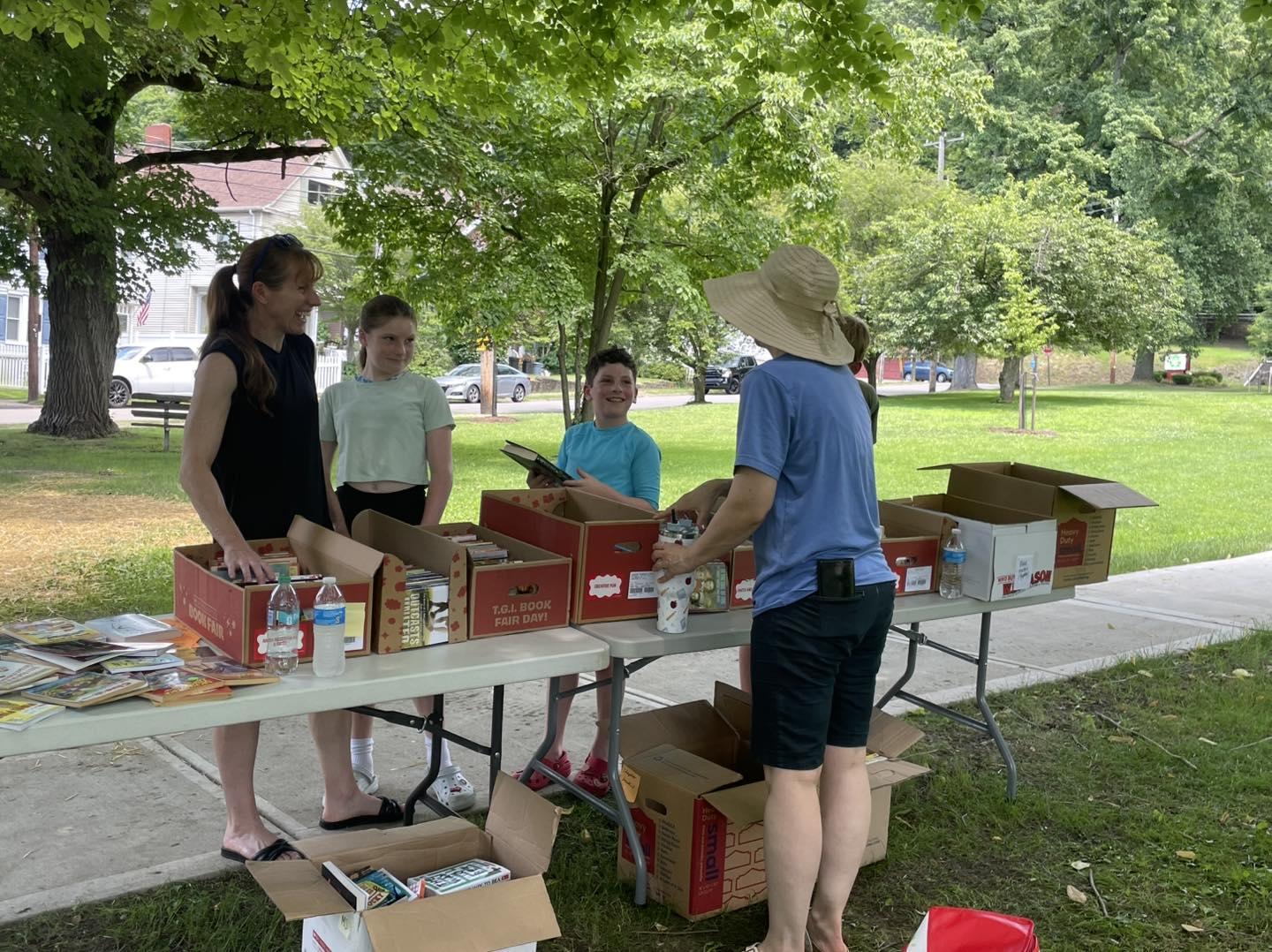 people talking at a table outside
