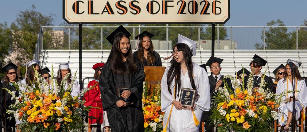 students walking on field at graduation