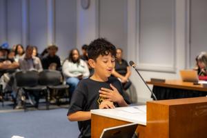 student at podium delivering their presentation