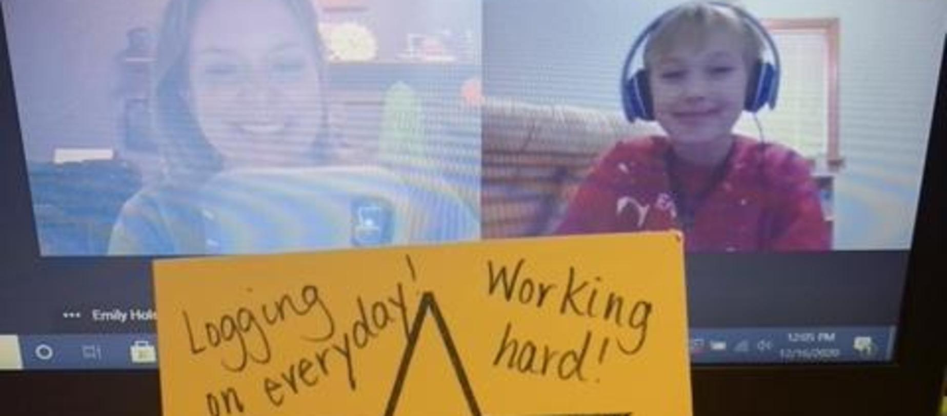 student receiving a star for working hard via computer screen