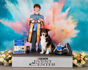 Sawyer Johnson with dog on podium with ribbons