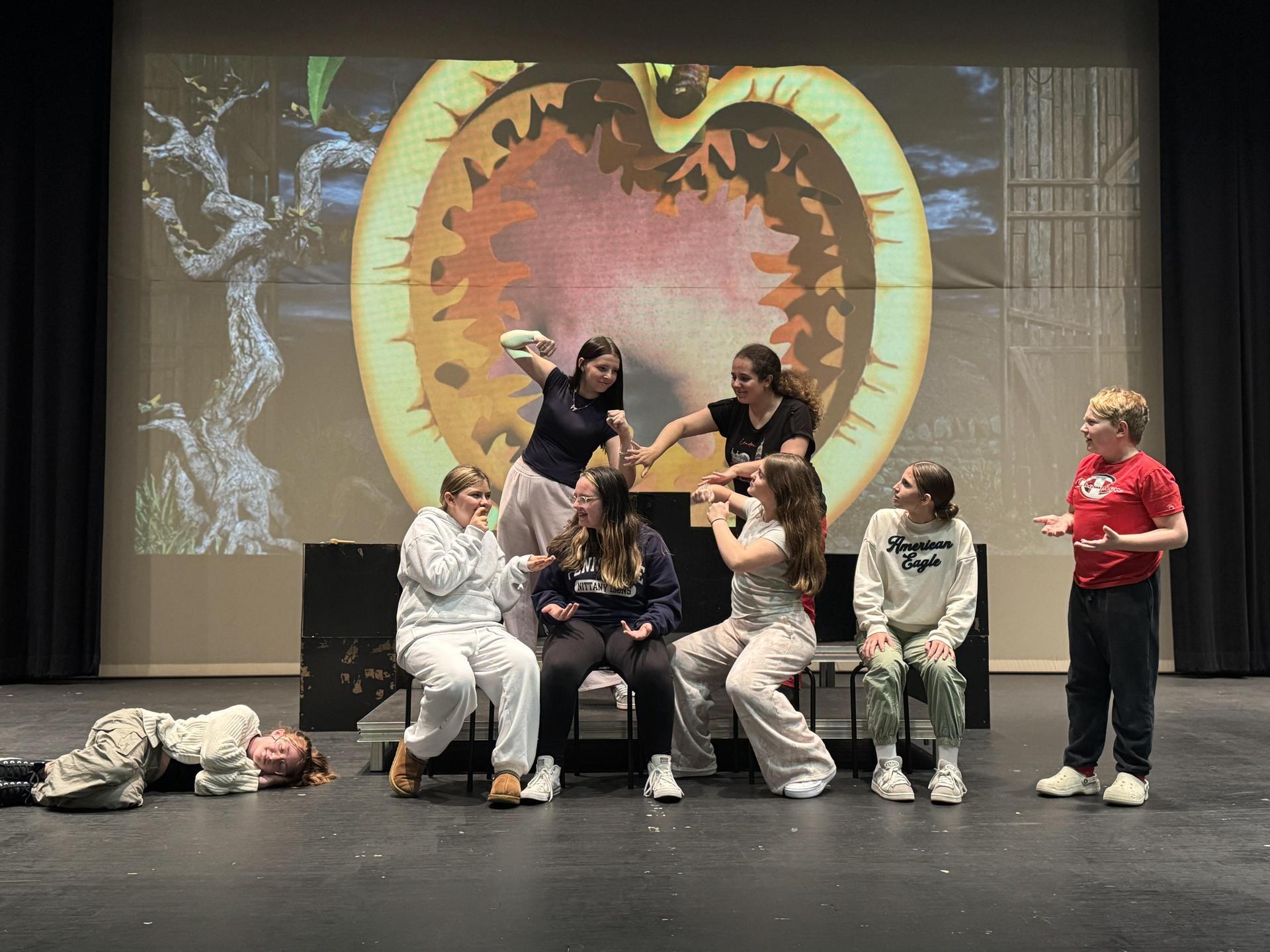 Students acting on stage.