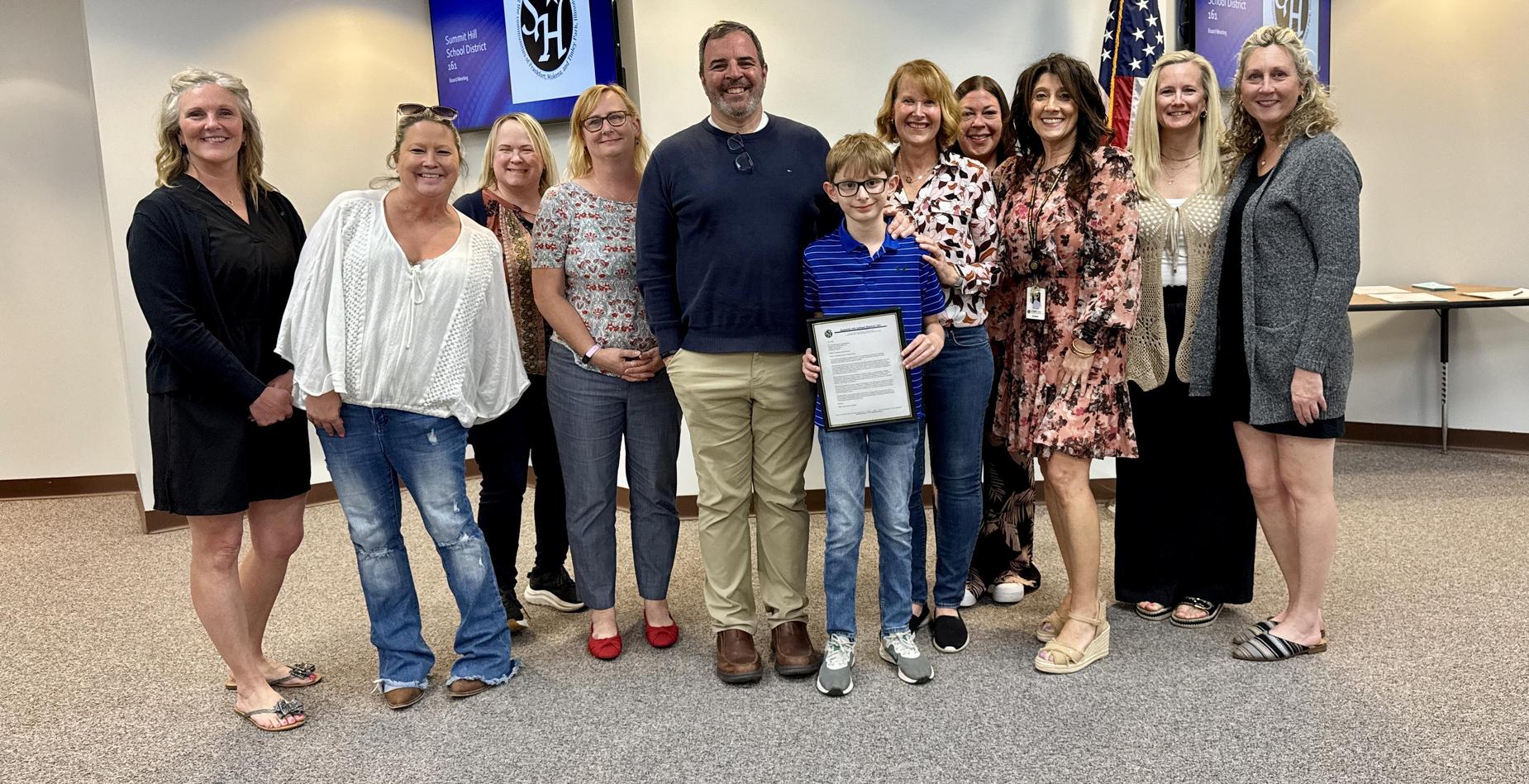 Group photo of the Indian Trail School Exemplary Student pictured with his family and several Summit Hill 161 staff members after being recognized during the May Board of Education meeting.